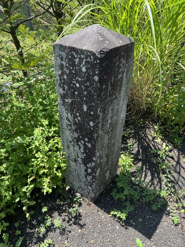 A weathered gravestone with inscriptions no longer legible